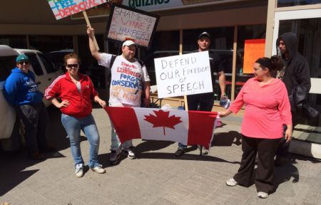 Organizer Angelle Provencher (red jacket), rally participant Dale McNabb (in black, behind the flag), and other rally participants before the anti-Bill C-51 action. (Photo by Scott Neigh)