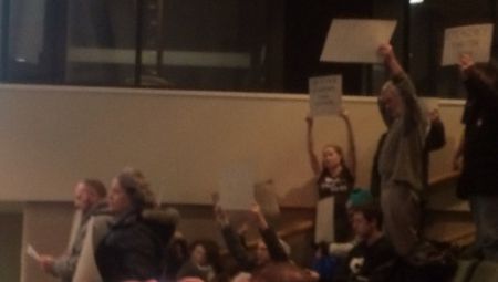 Members and supporters of the Sudbury Coalition Against Poverty interrupt tonight's city council meeting to demand emergency shelter for people sleeping on the streets. (Photo by Scott Neigh)