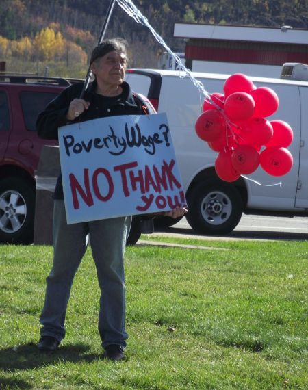 A demonstrator outside McDonald's on Notre Dame Avenue in Sudbury, Ontario, calling for an increase in the minimum wage to $14 an hour.