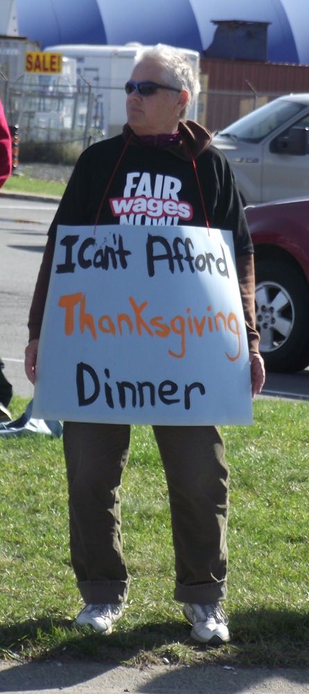 A demonstrator outside McDonald's on Notre Dame Avenue in Sudbury, Ontario, calling for an increase in the minimum wage to $14 an hour.