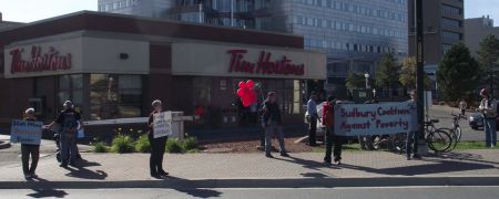 Demonstrators outside Tim Horton's at the corner of Cedar and Paris Streets in Sudbury, Ontario, calling for an increase in the minimum wage to $14 an hour.