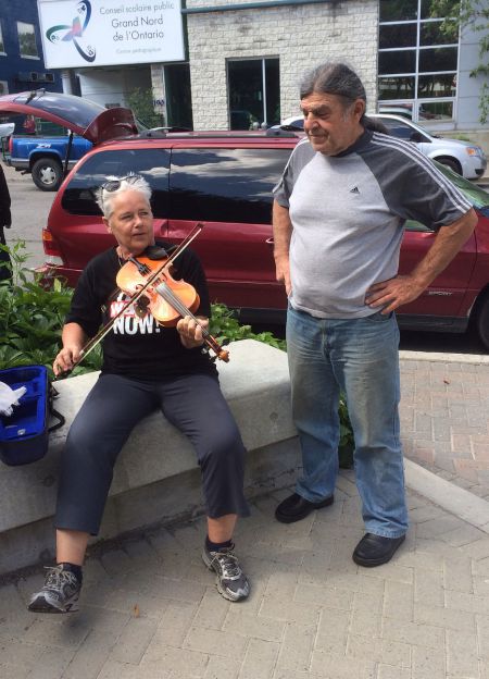 The event included music -- shown here is S-CAP member Cate Burns playing the fiddle.