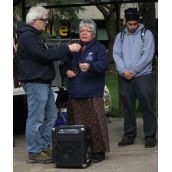 This photo shows S-CAP organizer Gary Kinsman holding the mic as Anishnabe elder Julia Ozawagosh gives an opening at the Friday afternoon event. Local Idle No More organizer Bruce McComber listens close behind. (Photo by Scott Neigh)